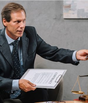 close-up-mature-male-adviser-holding-contract-hand-giving-pen