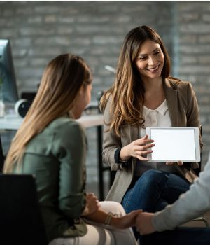 happy-insurance-agent-having-meeting-with-young-couple-showing-them-potential-investment-possibilities-touchpad-copy-space(1)